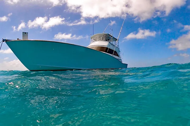 Slide: The Image of Custom Carolina Precision Sportfish 2000 on clear blue ocean under a bright sky. - 4