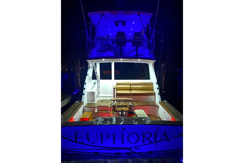 Slide: The Image of 2000 Custom Carolina Precision Sportfish boat with blue lighting at night, named "Euphoria." - 9