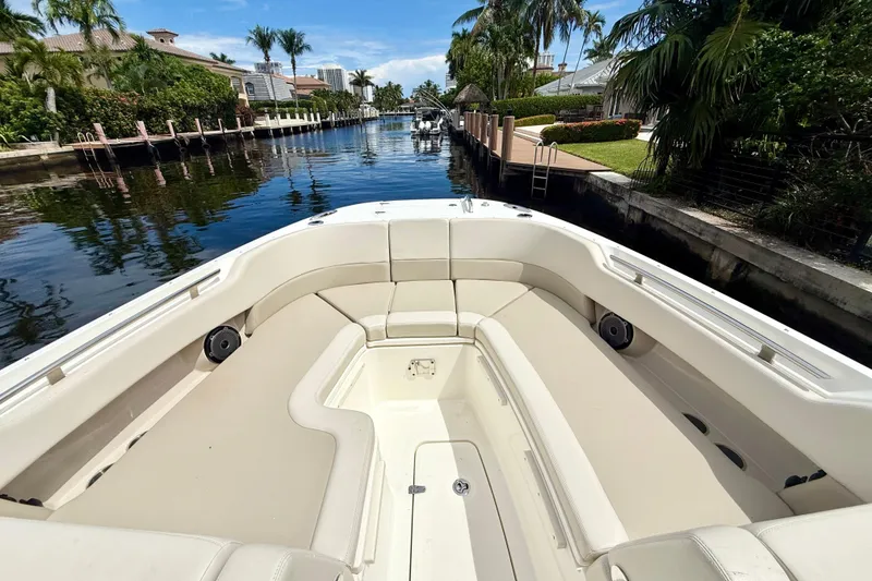 Slide: The Image of 2024 Boston Whaler 320 Vantage boat interior with luxurious seating, dockside view. - 10