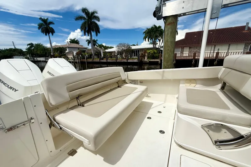 Slide: The Image of 2024 Boston Whaler 320 Vantage boat interior with seating and Mercury engines. - 12