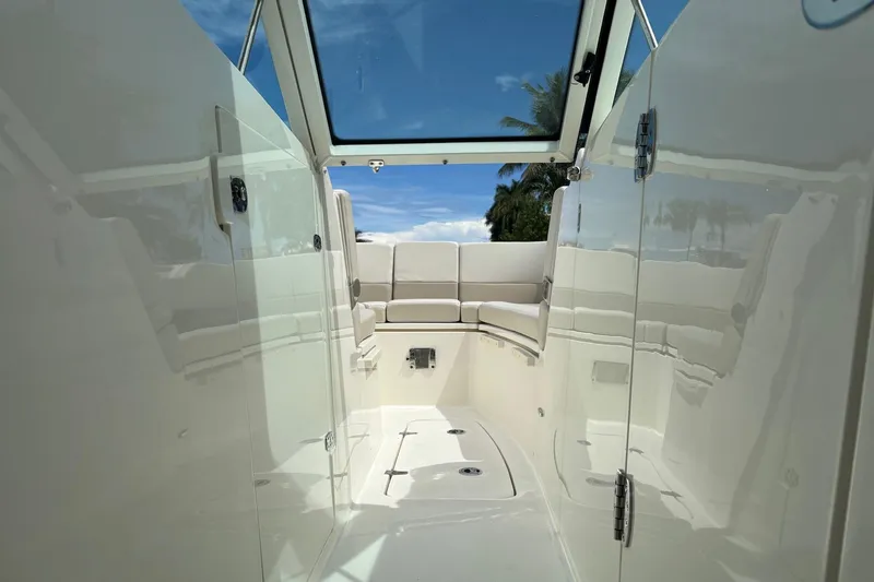 Slide: The Image of 2024 Boston Whaler 320 Vantage interior with seating, open sky view, and sleek design. - 17