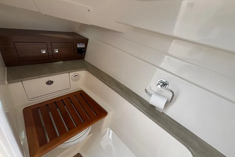 Slide: The Image of 2024 Boston Whaler 320 Vantage boat interior with wooden accents and modern amenities. - 20