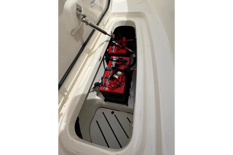 Slide: The Image of 2024 Boston Whaler 320 Vantage battery compartment with red batteries and wiring. - 24