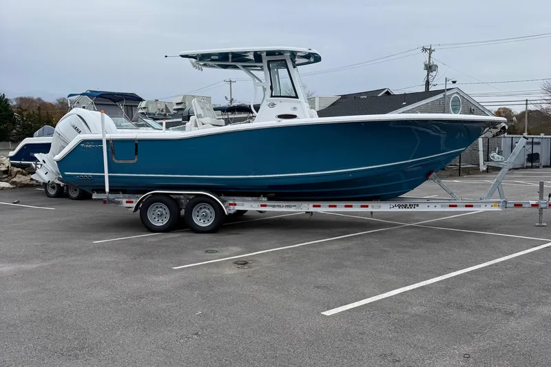 The Image of 2026 Tidewater 282 CC Adventure boat on trailer in parking lot. - 0