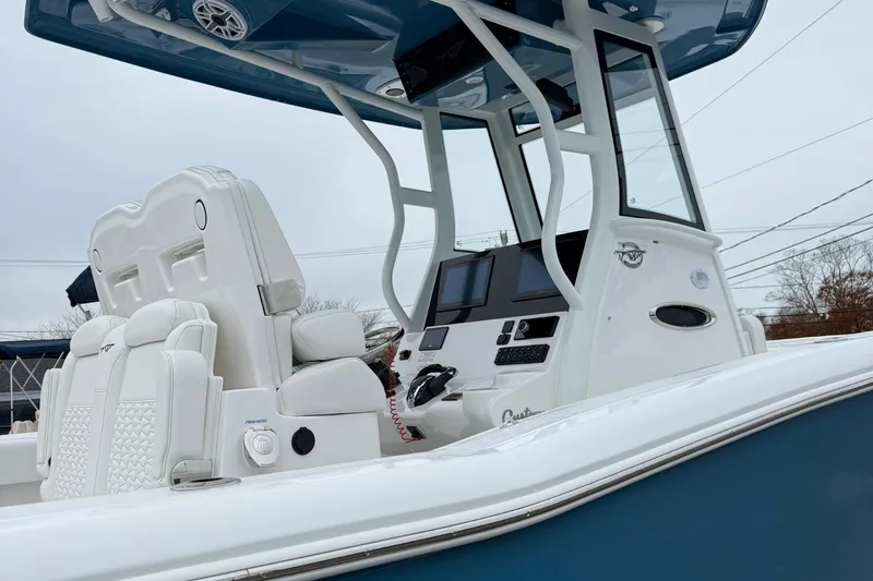 Slide: The Image of 2026 Tidewater 282 CC Adventure boat with Yamaha outboard engines, blue hull. - 10