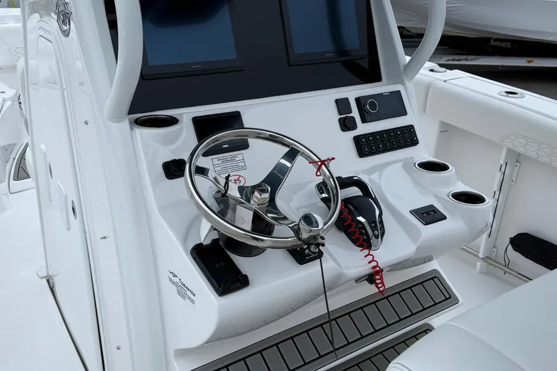 Slide: The Image of 2026 Tidewater 282 CC Adventure boat docked at marina, showcasing sleek design and spacious seating. - 16