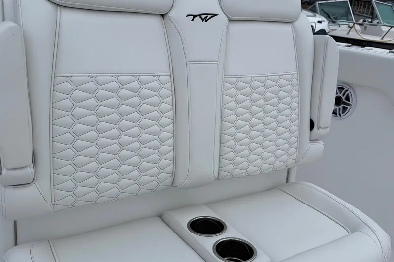 Slide: The Image of 2026 Tidewater 282 CC Adventure boat interior with seating and speakers. - 19