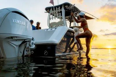 Slide: The Image of 2026 Tidewater 282 CC Adventure boat on trailer, parked near waterfront. - 2