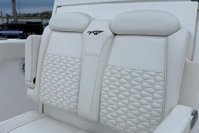 Slide: The Image of Interior of 2026 Tidewater 282 CC Adventure boat with white seating and speakers. - 20