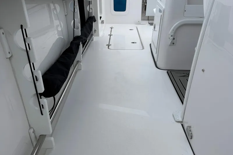 Slide: The Image of 2026 Tidewater 282 CC Adventure boat deck with cup holders and storage hatch. - 24