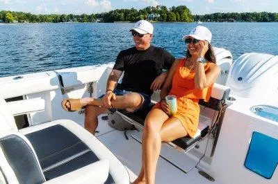 Slide: The Image of 2026 Tidewater 282 CC Adventure boat on trailer, parked near marina. - 3