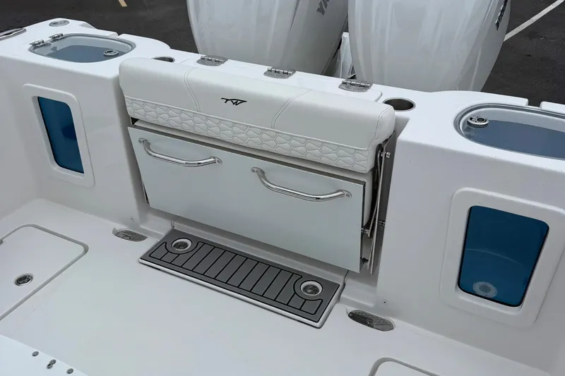 Slide: The Image of Tidewater 282 CC Adventure 2026 boat deck with rod holders and storage compartment. - 42