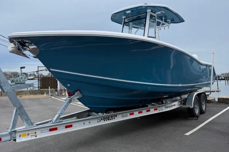 Slide: The Image of 2026 Tidewater 282 CC Adventure boat with dual outboard engines and stainless steel propellers. - 5
