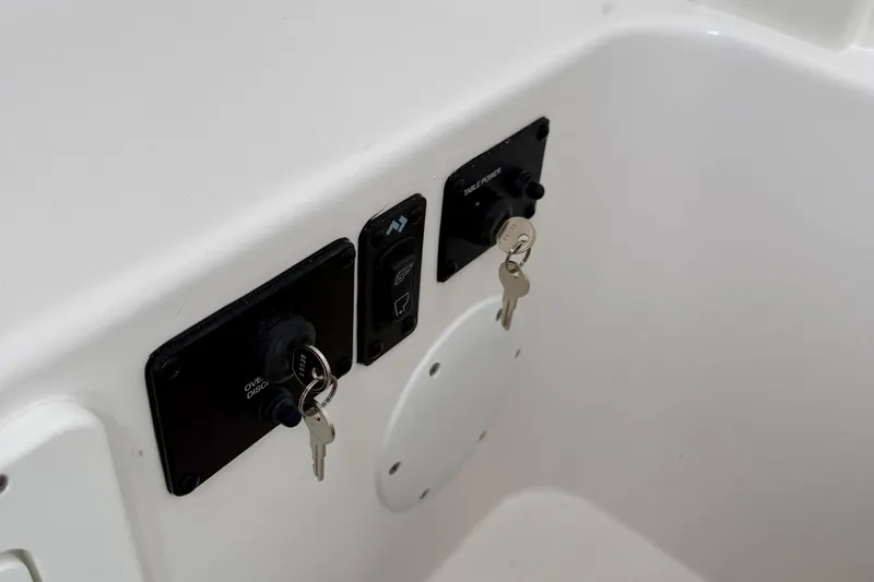 Slide: The Image of 2026 Tidewater 282 CC Adventure boat interior with compact marine toilet and storage area. - 51