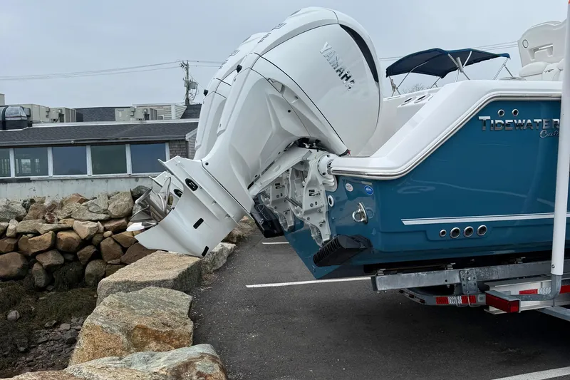 Slide: The Image of 2026 Tidewater 282 CC Adventure boat, rear view with dual engines on trailer. - 6