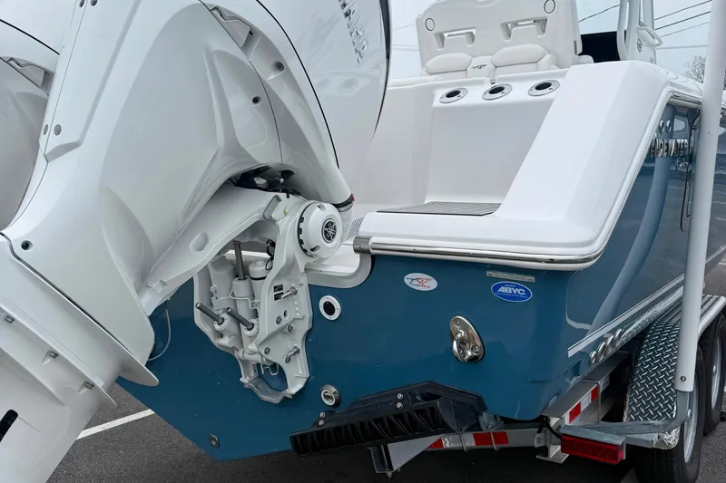 Slide: The Image of 2026 Tidewater 282 CC Adventure boat on trailer, featuring sleek blue hull design. - 8