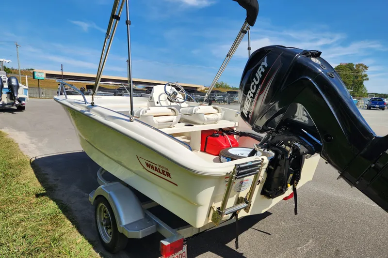 Slide: The Image of 2018 Boston Whaler 130 Super Sport boat on trailer with Mercury outboard motor. - 3