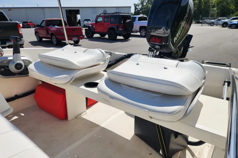 Slide: The Image of 2018 Boston Whaler 130 Super Sport boat interior with seating and Mercury engine. - 7