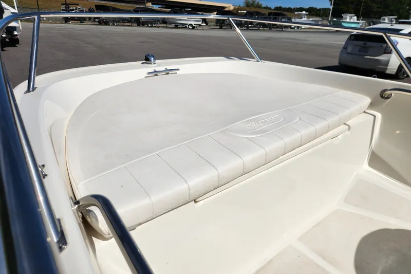 Slide: The Image of 2018 Boston Whaler 130 Super Sport boat interior with cushioned seating. - 8