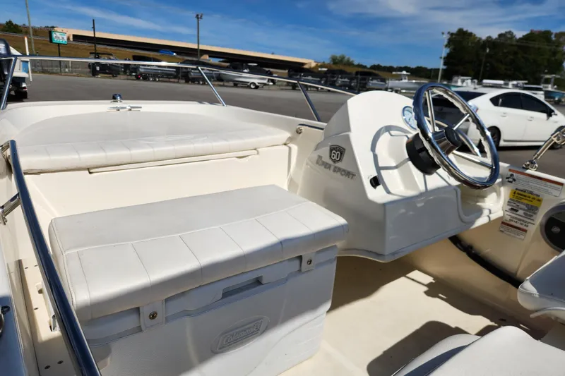 Slide: The Image of 2018 Boston Whaler 130 Super Sport boat interior with steering wheel and seating. - 9