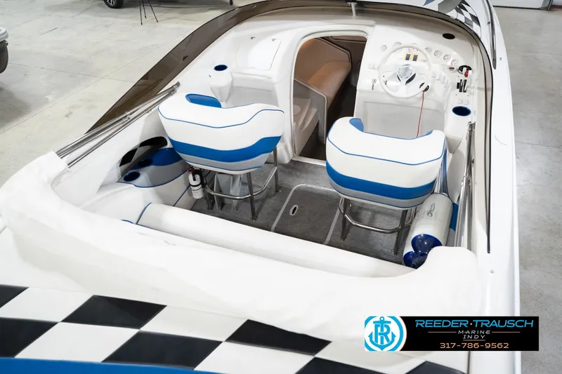 Slide: The Image of Interior of a 2001 Nordic Heat 28 boat with blue and white seating. - 14