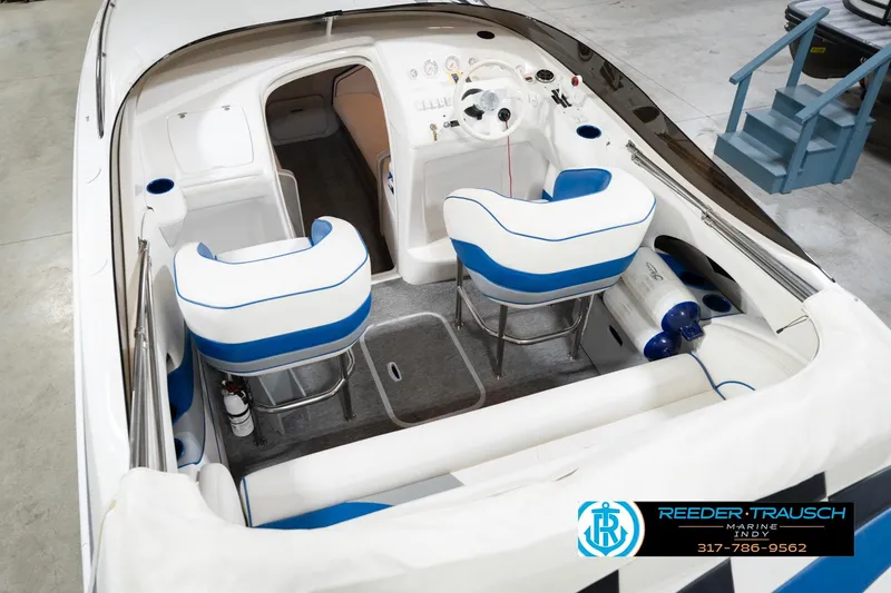 Slide: The Image of Interior of a 2001 Nordic Heat 28 boat with blue and white seating. - 15
