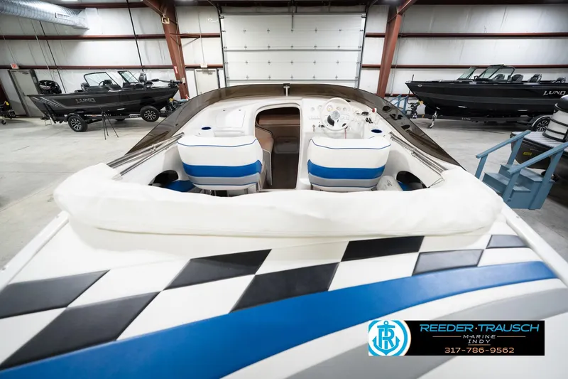 Slide: The Image of 2001 Nordic Heat 28 boat interior with blue and white seating in a showroom. - 16
