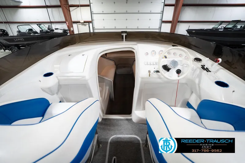 Slide: The Image of Interior of a 2001 Nordic Heat 28 boat with blue and white seating. - 17