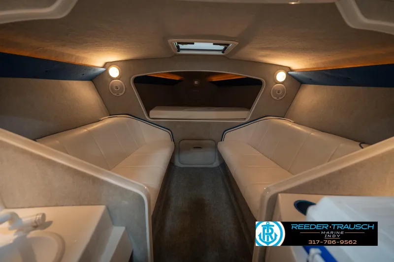 Slide: The Image of Interior of a 2001 Nordic Heat 28 boat with white seating and ambient lighting. - 19