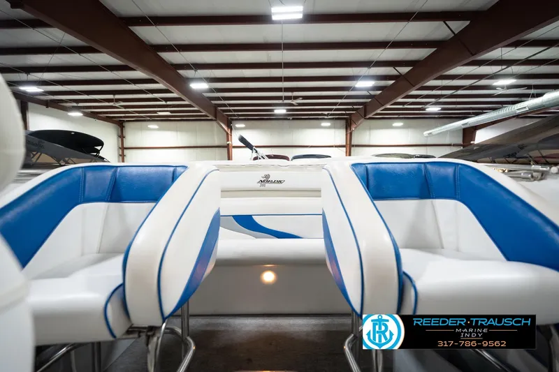 Slide: The Image of 2001 Nordic Heat 28 boat interior with blue and white seating in a showroom. - 21