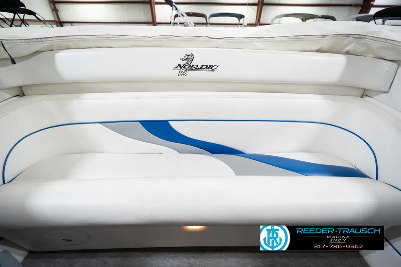 Slide: The Image of 2001 Nordic Heat 28 boat interior with white and blue seating, Reeder-Trausch Marine logo. - 22