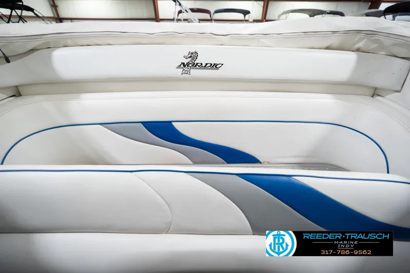 Slide: The Image of White and blue interior of a 2001 Nordic Heat 28 boat, featuring sleek design elements. - 23