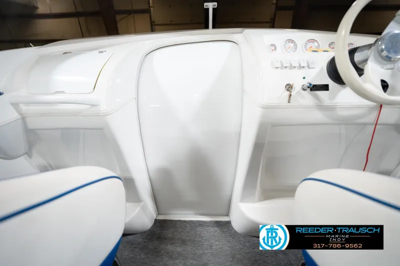 Slide: The Image of Nordic Heat 28 boat dashboard, white interior, steering wheel, gauges, Reeder-Trausch Marine logo. - 25