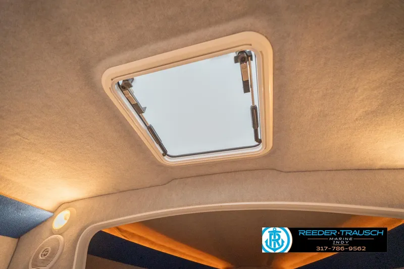 Slide: The Image of Ceiling hatch inside 2001 Nordic Heat 28 boat, featuring interior lighting and speaker. - 26