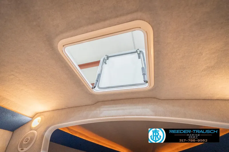 Slide: The Image of Interior view of Nordic Heat 28 boat, featuring a ceiling hatch and ambient lighting. - 27