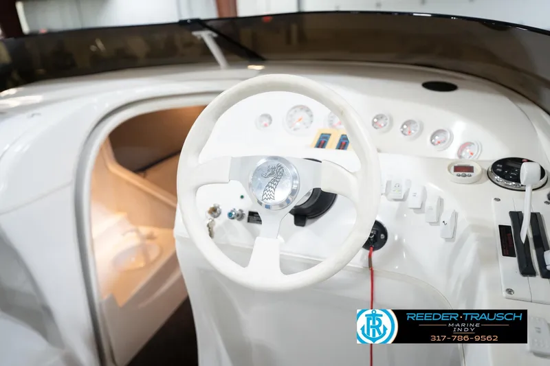 Slide: The Image of Interior of a 2001 Nordic Heat 28 boat showing steering wheel and dashboard controls. - 28