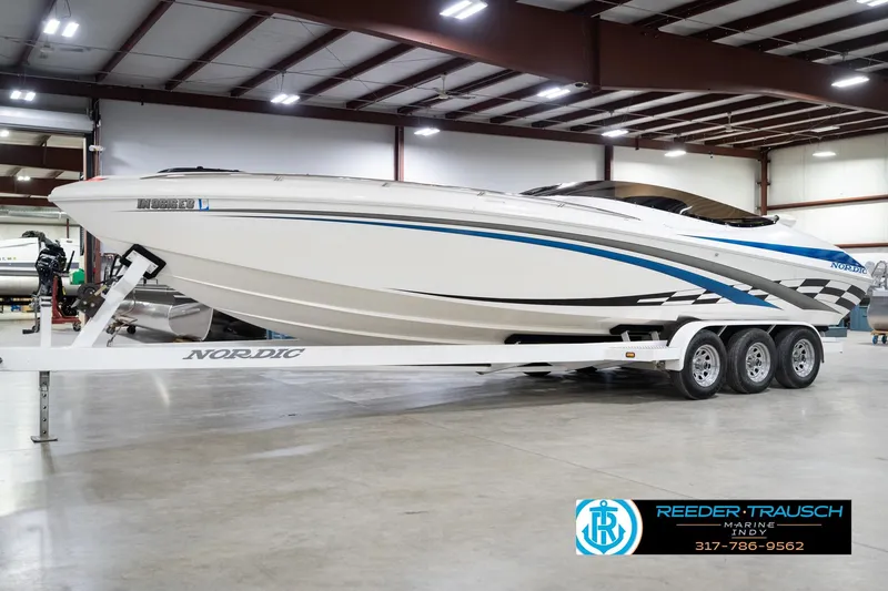 Slide: The Image of Nordic Heat 28 boat, 2001 model, on trailer in indoor showroom. - 3