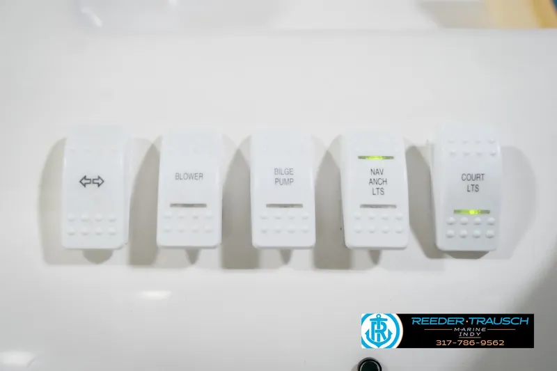 Slide: The Image of Control panel switches on a 2001 Nordic Heat 28 boat. - 31