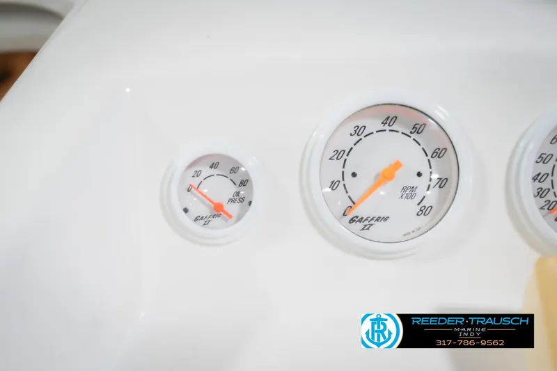 Slide: The Image of Gauges on a 2001 Nordic Heat 28 boat dashboard, showing oil pressure and RPM. - 32