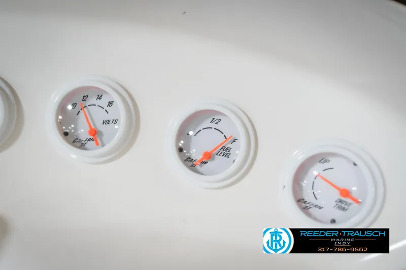 Slide: The Image of Gauges on Nordic Heat 28 boat dashboard, showing volts, fuel level, and engine trim. - 34