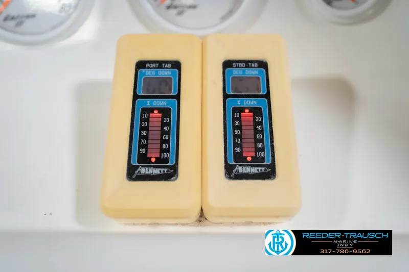 Slide: The Image of Two Bennett trim tab controls on a Nordic Heat 28 boat dashboard, 2001 model. - 35