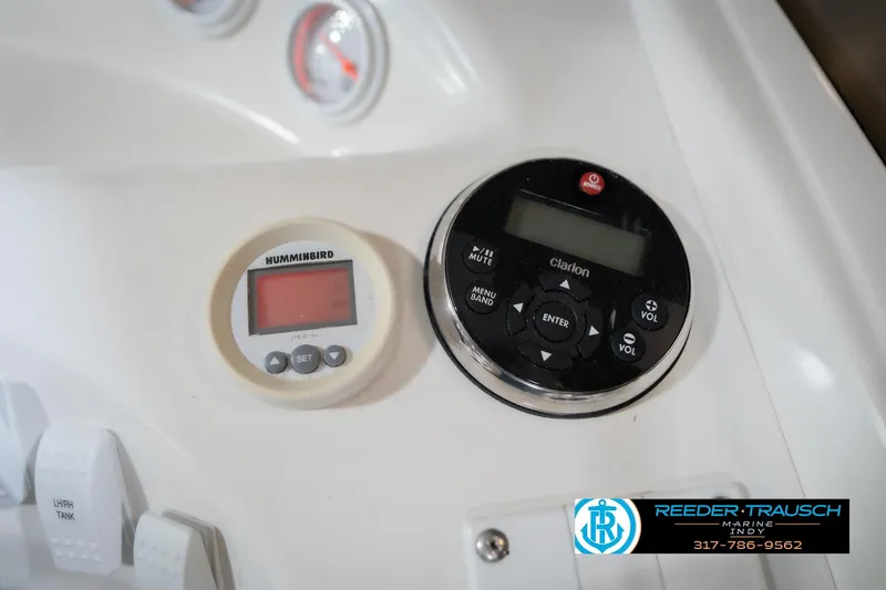 Slide: The Image of Control panel of a 2001 Nordic Heat 28 boat with Humminbird and Clarion displays. - 36