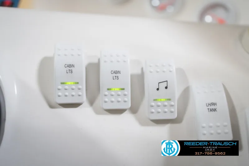 Slide: The Image of Switch panel of Nordic Heat 28 boat, featuring cabin lights and music controls. - 37
