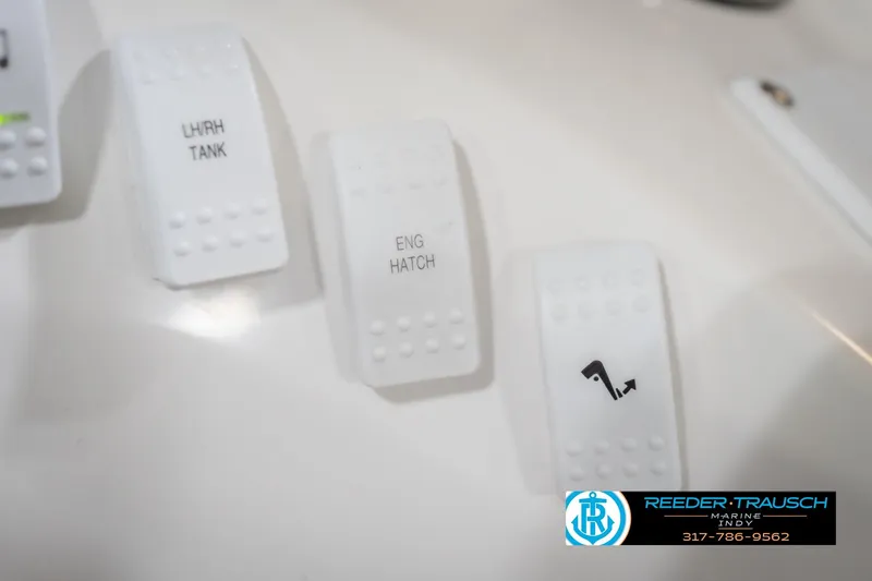 Slide: The Image of White control switches labeled "LHRH Tank" and "Eng Hatch" on Nordic Heat 28 boat. - 38