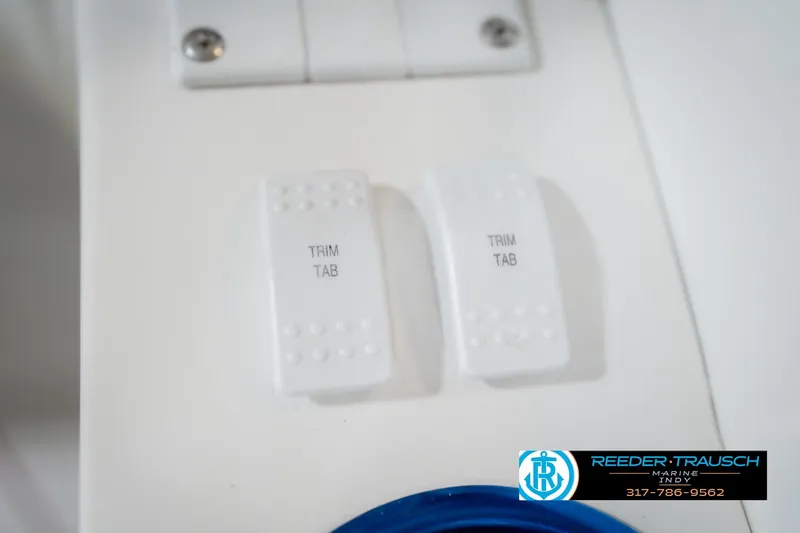 Slide: The Image of White trim tab switches on Nordic Heat 28 boat, 2001 model. - 39