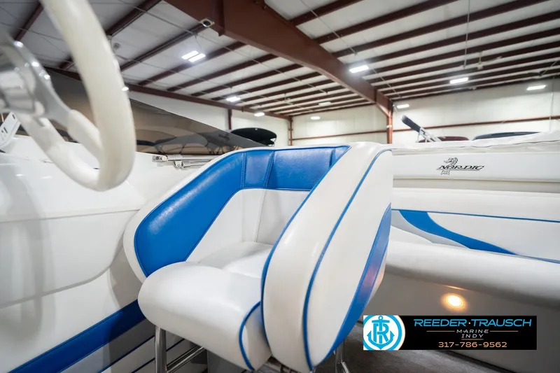 Slide: The Image of Blue and white interior of 2001 Nordic Heat 28 boat in showroom. - 44
