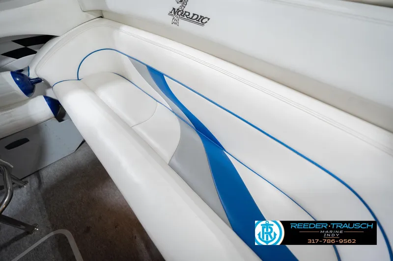 Slide: The Image of Interior of a 2001 Nordic Heat 28 boat with white and blue seating. - 45