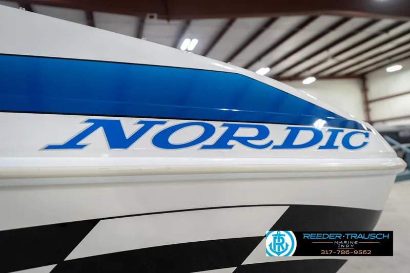Slide: The Image of Close-up of 2001 Nordic Heat 28 boat with blue and white design. - 54
