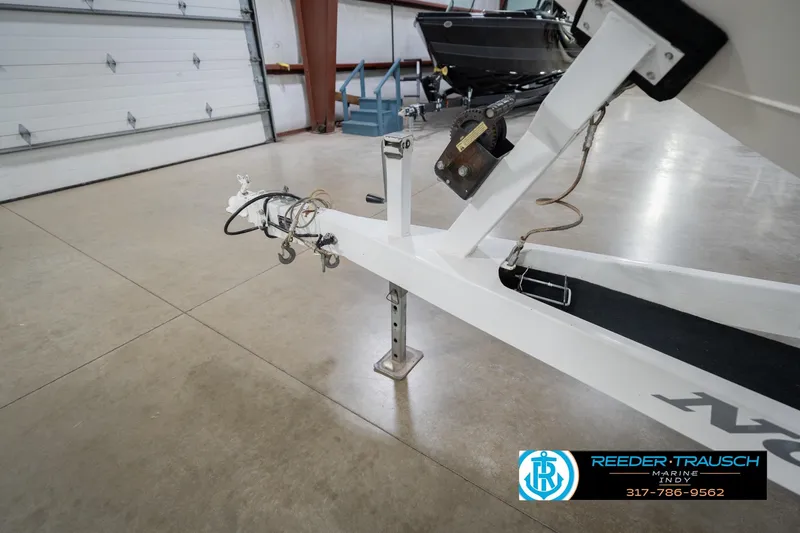 Slide: The Image of Trailer hitch of a 2001 Nordic Heat 28 boat in a garage setting. - 56