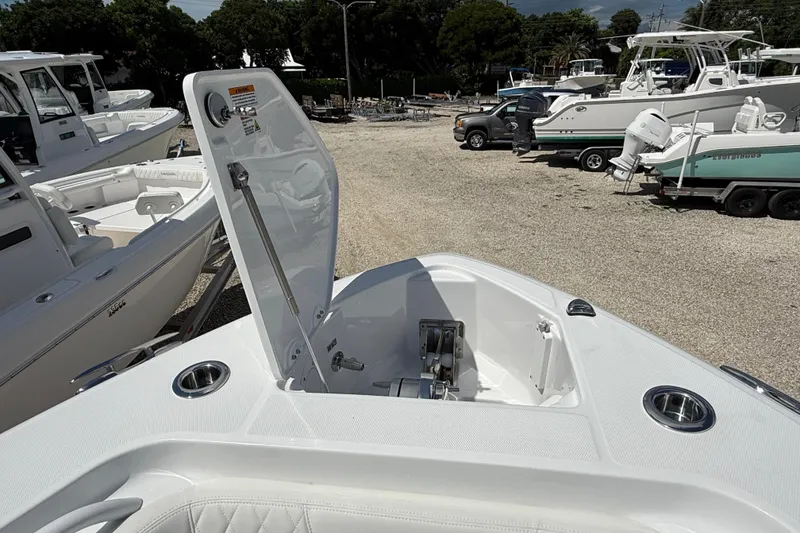 Slide: The Image of 2026 Everglades 335 Center Console boat with open anchor locker, docked among other boats. - 10